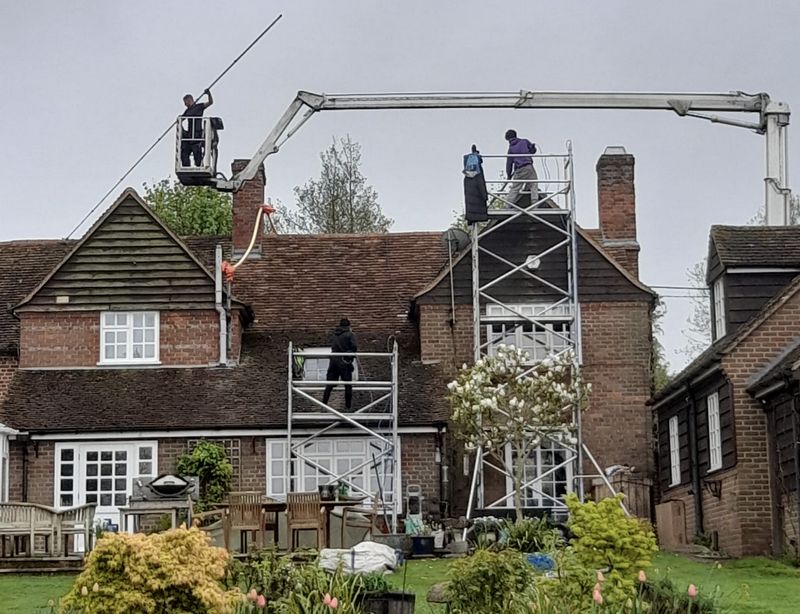 The Roof Moss Cleaners using cherry picker and scaffolding to clean roof safely and professionally in Burton Latimer, Northamptonshire